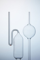 various empty chemistry glassware on grey