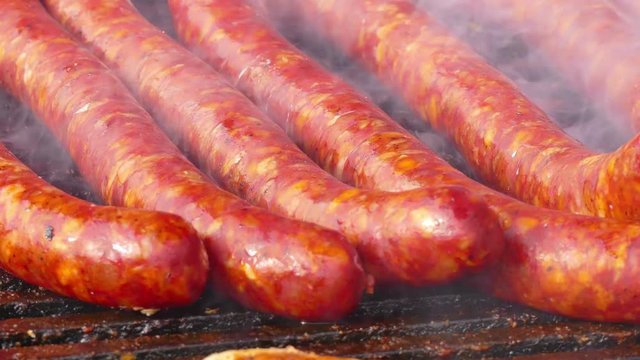 Pork sausages and meat on grill, 4k Video Clip
