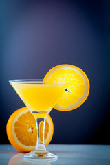 Isolated drink. Glass of orange juice and slices of orange fruit isolated on dark background