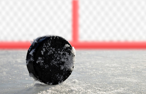 Hockey puck lying on a ice rink.