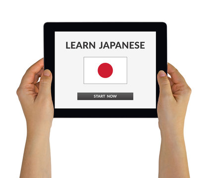 Hands holding digital tablet computer with learn Japanese concept on screen. Isolated on white. All screen content is designed by me