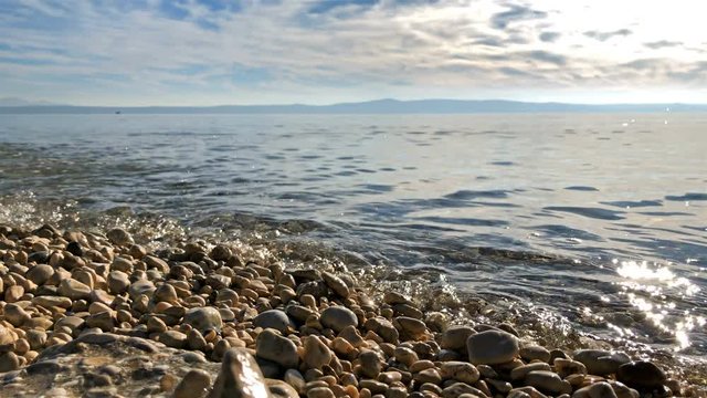 Pebble beach coasline and sea landscape on sunny day at Croatian coast