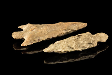 Two Indian arrowheads and black background