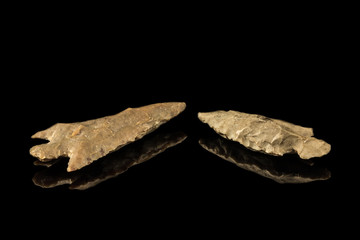 Two Indian arrowheads and black background