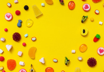 colorful candy on the yellow background