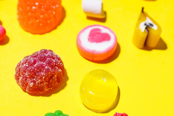 colorful candy on the yellow background