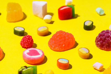colorful candy on the yellow background