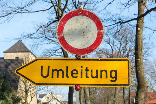 street sign with german text umleitung, in english detour
