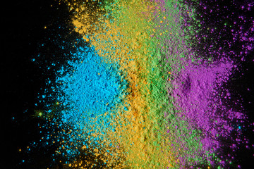 top view of colorful holi powder isolated on black, Hindu spring festival