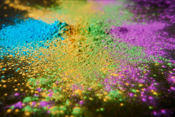 colorful holi powder on black, traditional Indian festival of colours