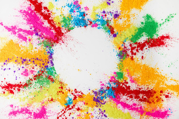 circle frame of multicolored traditional powder, isolated on white, holi festival