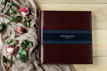 leather covered wedding photo album top view with rose flowers decoration