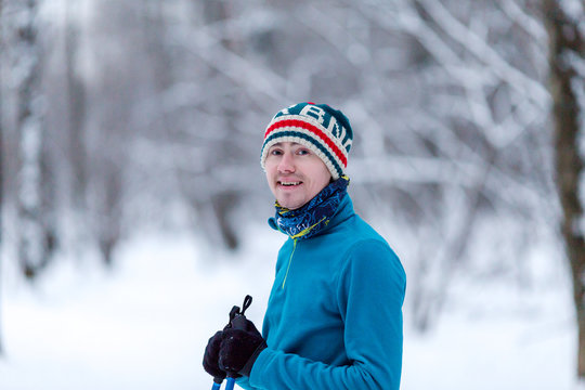 Portrait of male skier in forest at winter