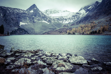 Mountain lake with reflection in the mirrored surface of the rocks. The beauty of the mountain country and nature.