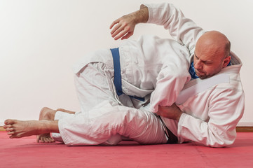 Fototapeta premium BJJ Brazilian jiu-jitsu training demonstration in traditional kimono