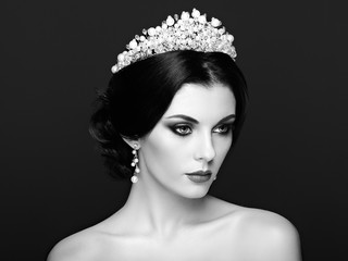Fashion Portrait of Beautiful Woman with Tiara on head. Elegant Hairstyle. Perfect Make-Up and Jewelry. Red Lips. Black and White photo © Oleg Gekman