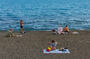 People are resting on the Black Sea coast in Sudak in the Crimea.