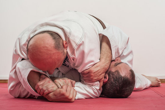 Brazilian jiu-jitsu training demonstration in traditional kimono