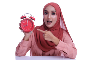 Business, learning or Working time conceptual with portrait Muslim Asian woman holding alarm clock on white background