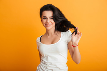 Cheerful young woman standing isolated