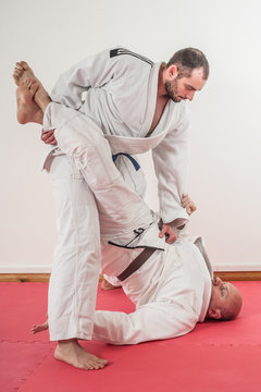 Brazilian jiu-jitsu training demonstration in traditional kimono