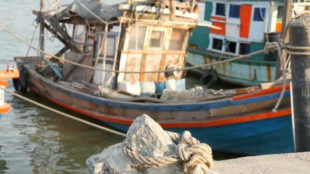 Old wooden half-ruined ship moored on a fishing dock