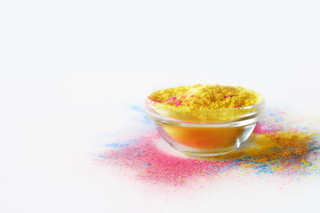 Indian Holi festival yellow colour in bowl on white background.