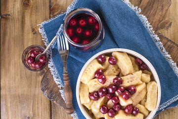 Traditional Russian food from dough and cheese with cherries. Healthy food. For children and the whole family. Free space for text. Rustic.