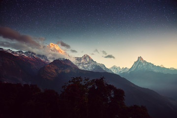 Night landscape on early morning. Starry sky with over the mountains.