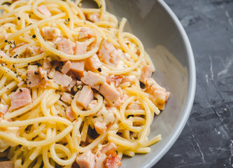 Tasty pasta with bacon and cheese. Selecitve focus.