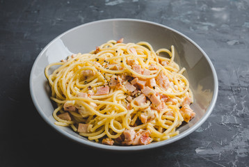 Tasty pasta with bacon and cheese. Selecitve focus.