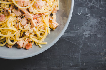 Tasty pasta with bacon and cheese. Selecitve focus.