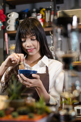 Barista woman preparing pouring coffee behind the counter in the coffee shop, Woman learning how to make a coffee.