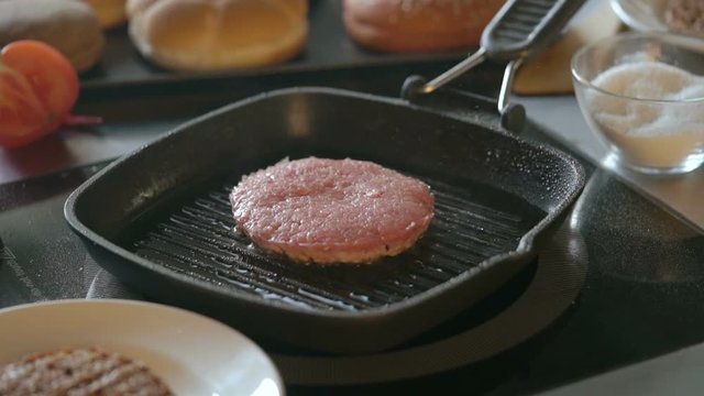 Fresh meat cutlet in a frying pan grill