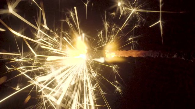 Firework sparkler burning on black background