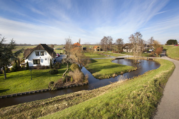 Dutch polder landscape with a farm and some houses