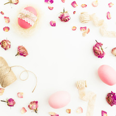 Frame of Easter pink eggs with twine, roses flowers and tapes on white background, Top view, Fat lay. Easter holiday