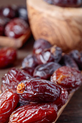Juicy dates on wooden table .