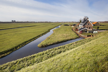 Dutch polder landscape with a farm and some houses