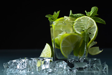 Cocktail with lime, ice and peppermint .