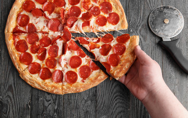 Hand pulls pizza - 193423134