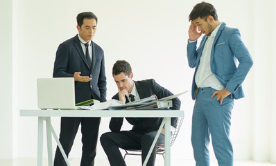 They are meeting new project so serius.Businessman looking at taplet and information in office.Businessman working at office with documents file on his desk.Meeting start up project