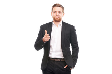 Portrait of young Caucasian businessman in black suit and white shirt posing on white background