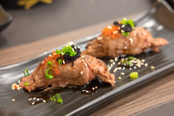 Set of grilled Wagyu beef sushi with Flying fish roe or Tobiko on plate