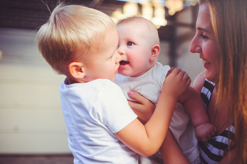 woman mother with two young children entertain girl embrace, concept maternity and parenting