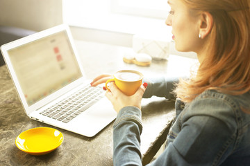 Attractive hipster young woman in modern loft cafe coffee shop restaurant. Writer, blogger, designer, freelancer, remote work process. E-shopping, online shopping, m-shopping.
