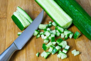Cut a fresh cucumber to prepare different dishes.