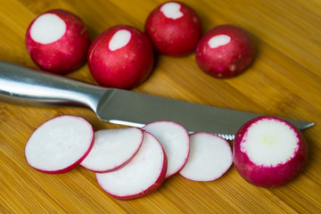 Cut fresh radishes to prepare a variety of dishes.