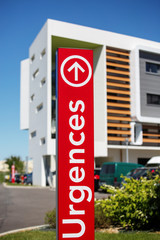 Closeup of vertical red sign - "Emergency" ("Urgences" in French).