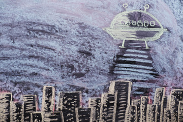 Figure aliens kidnap people against the city skyline